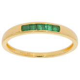 Elegant gold ring featuring green emerald accents, perfect for adding a touch of luxury to any outfit.